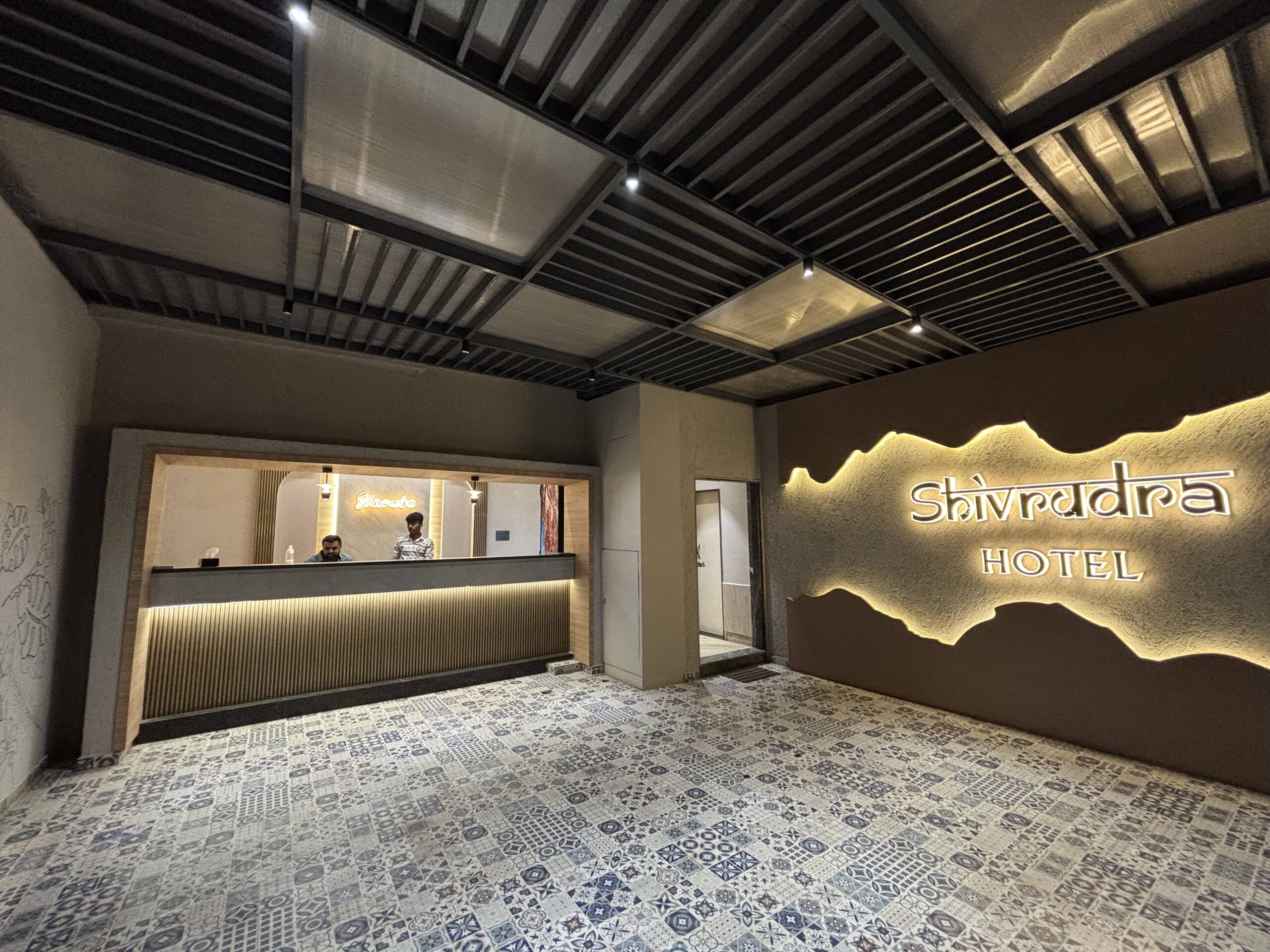 Reception area of shivrudra hotel lohegaon with hotel name signage