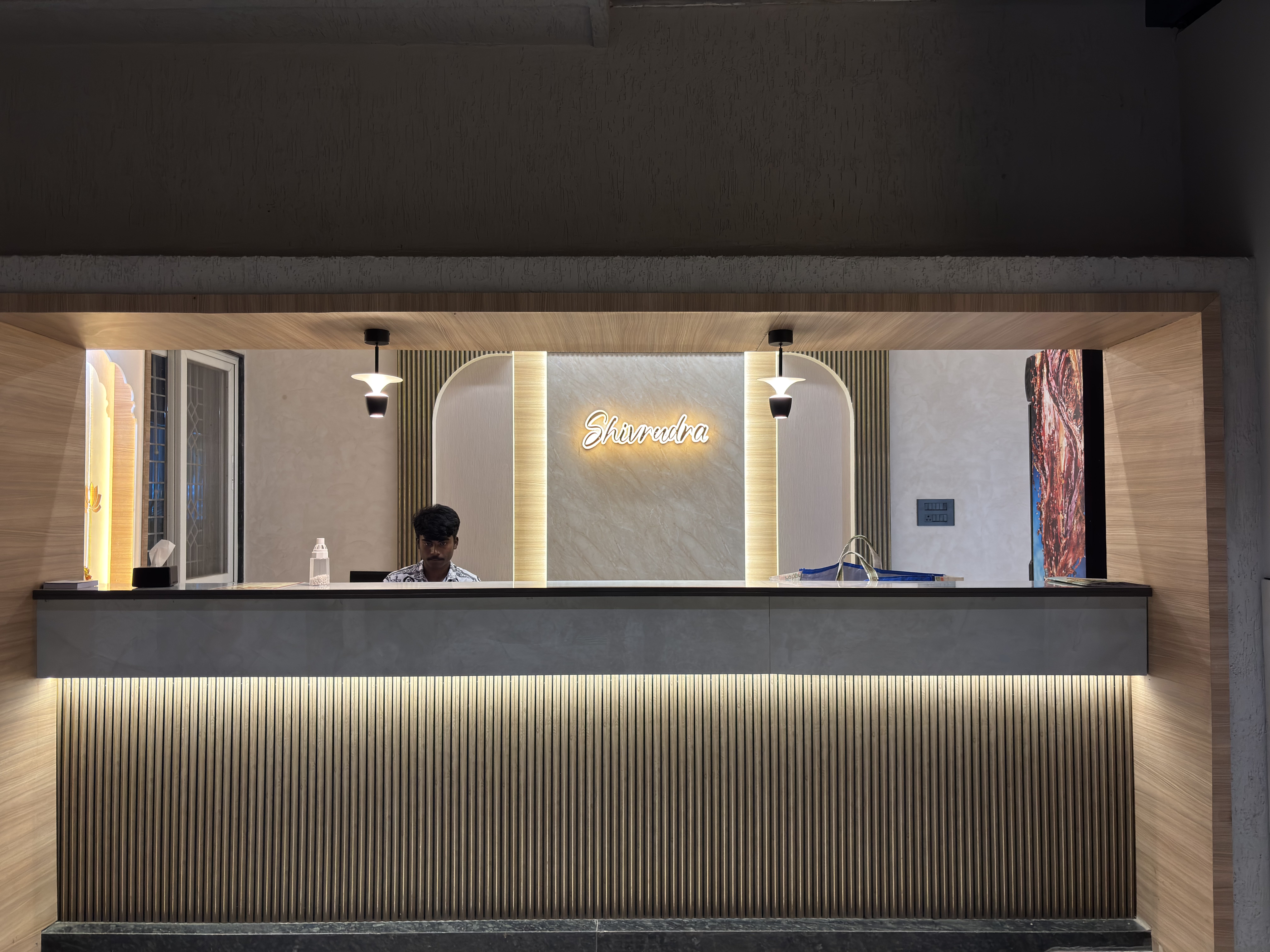 Reception area of shivrudra hotel lohegaon with hotel name signage