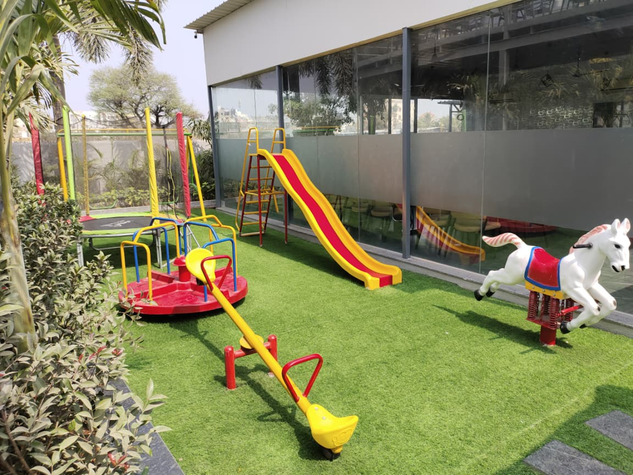 Small kids play zone near outdoor seating at Shivrudra Hotel Lohegaon Pune