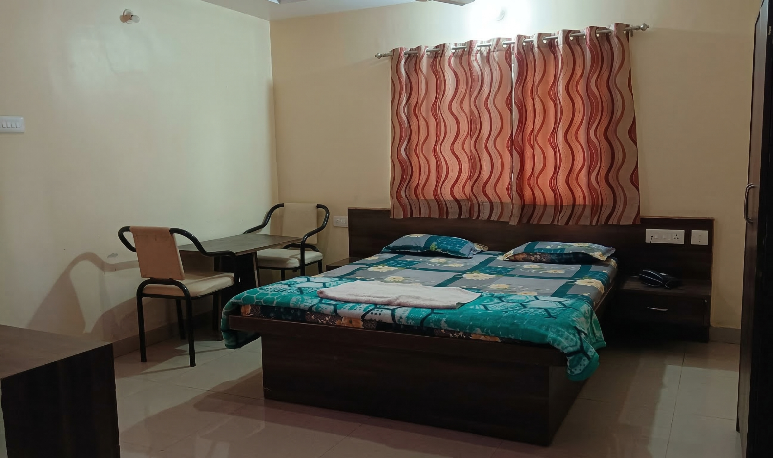 Regular non AC room with double bed and TV at Shivrudra Hotel Lohegaon Pune