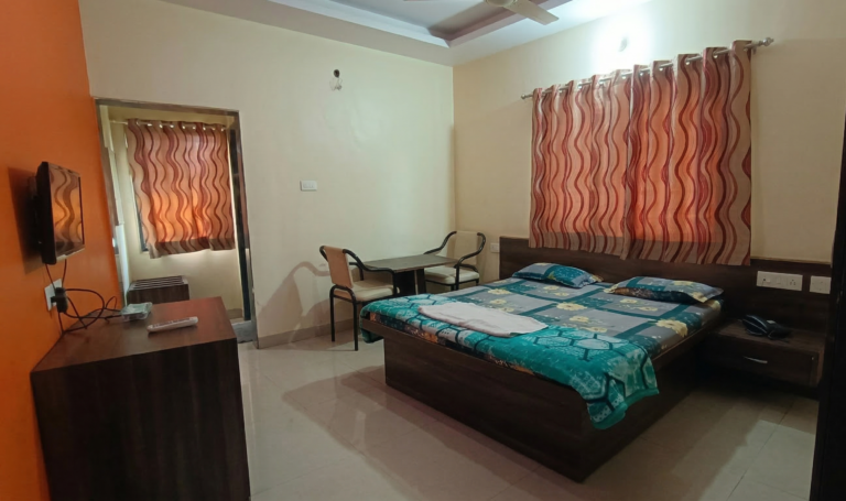 Regular non AC room with double bed and TV at Shivrudra Hotel Lohegaon Pune